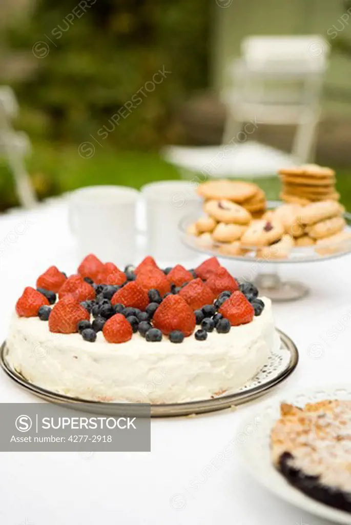 Strawberry blueberry cake on dessert table
