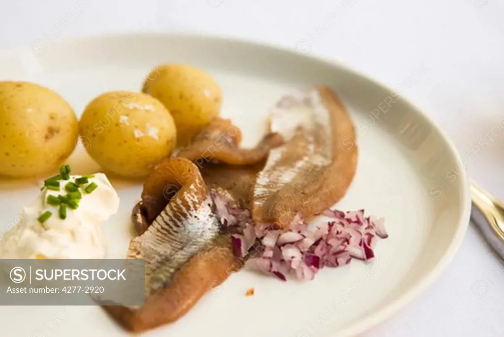 New potatoes with pickled herring and sour cream