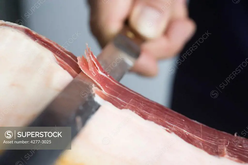 Slicing prosciutto, close-up