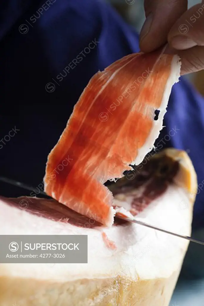 Slicing prosciutto, close-up