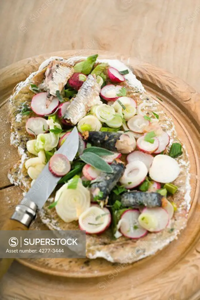 Semolina pizza with sardines and radishes