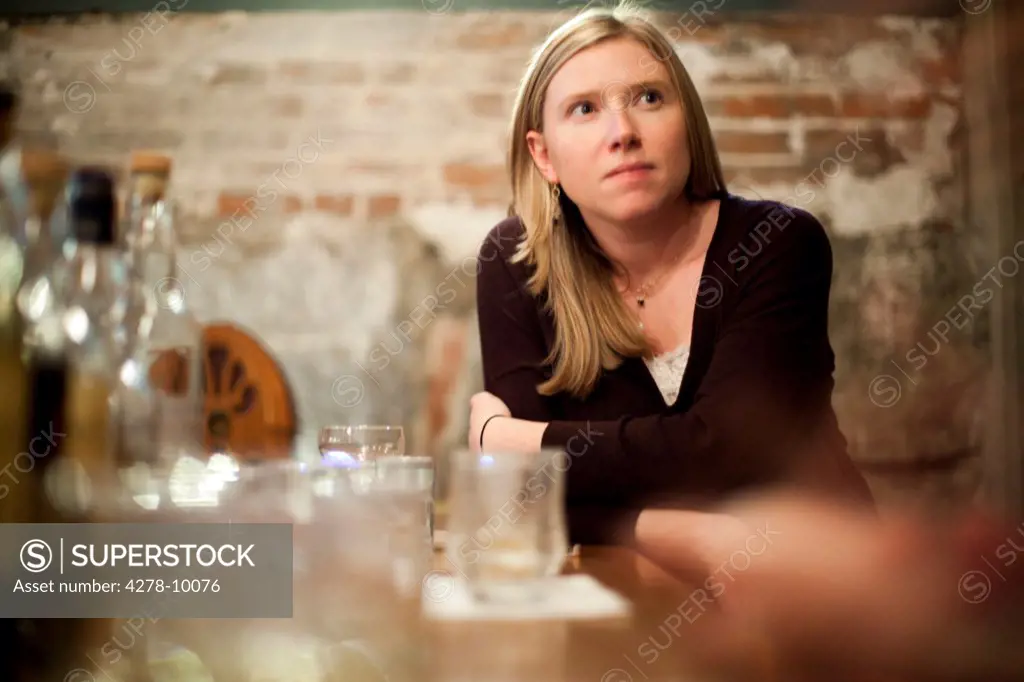 Woman Sitting in Bar