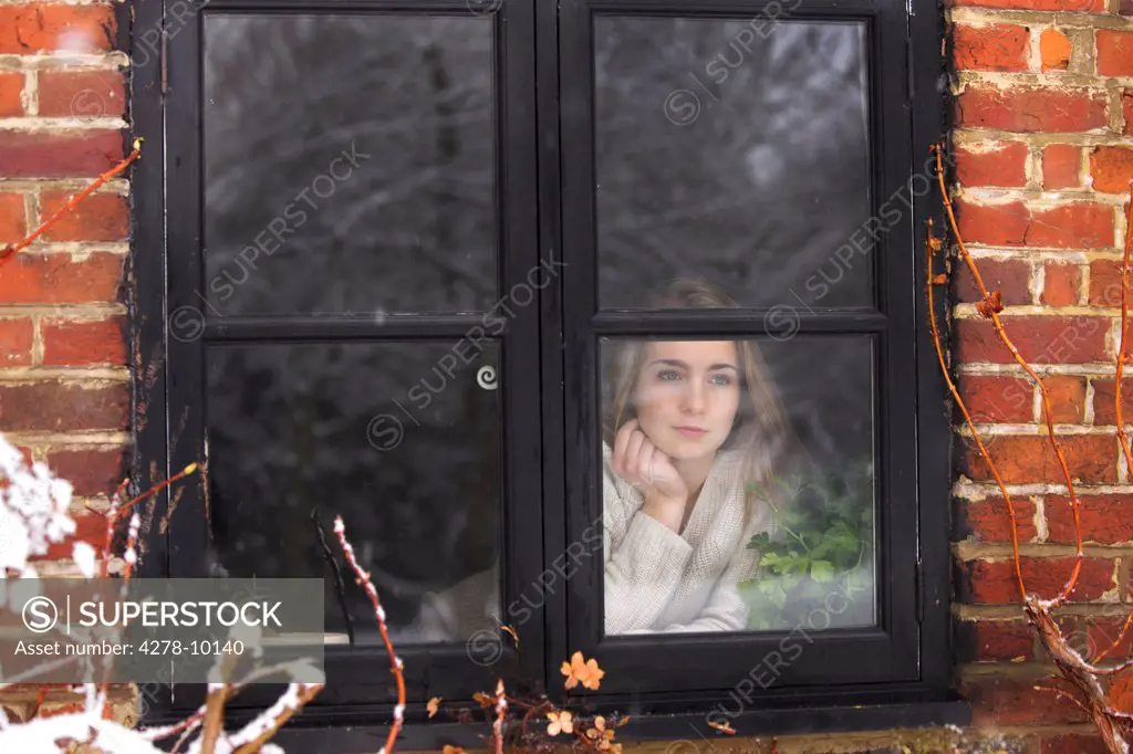 Teenage Girl Looking Out of Window
