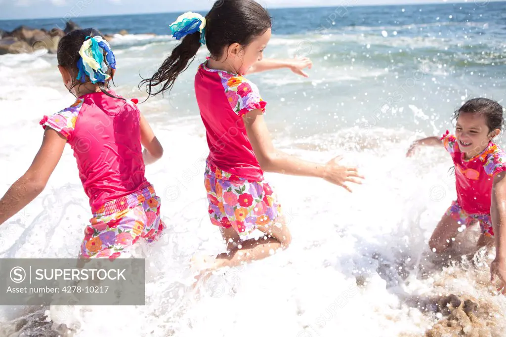 Girls in Matching Outfit Playing in Sea Water