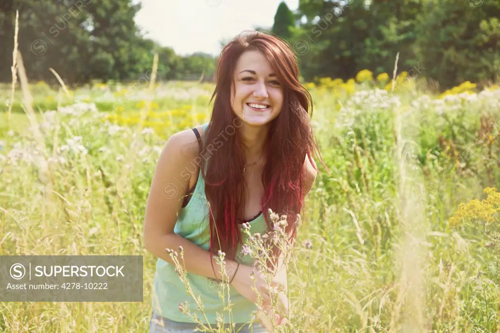 Smiling Teenage Girl in Meadow