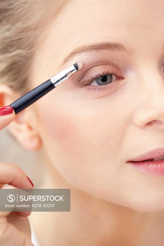Close-up View of Woman Applying Eye Shadow