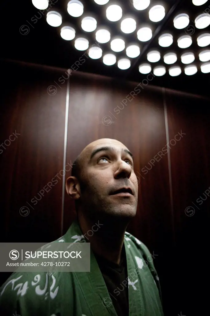 Man In Elevator Looking Up