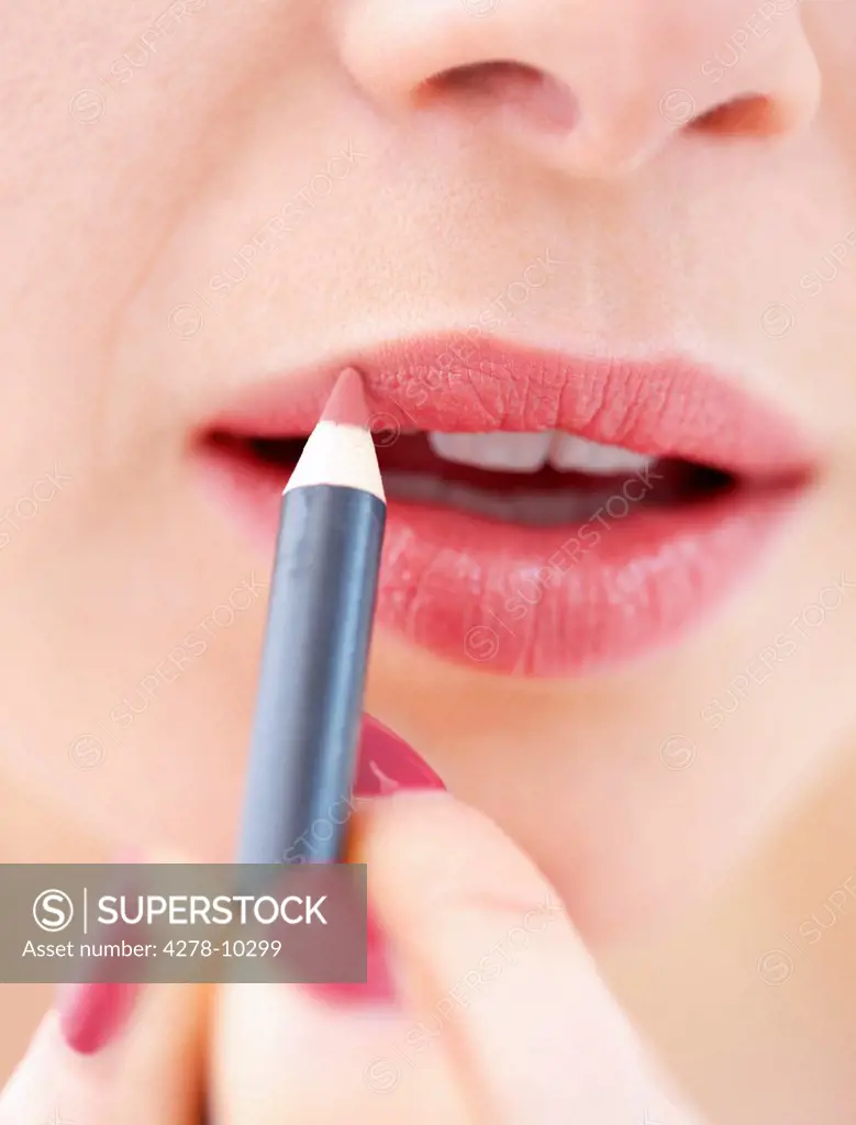 Close-up View of Woman Using Lip Pencil