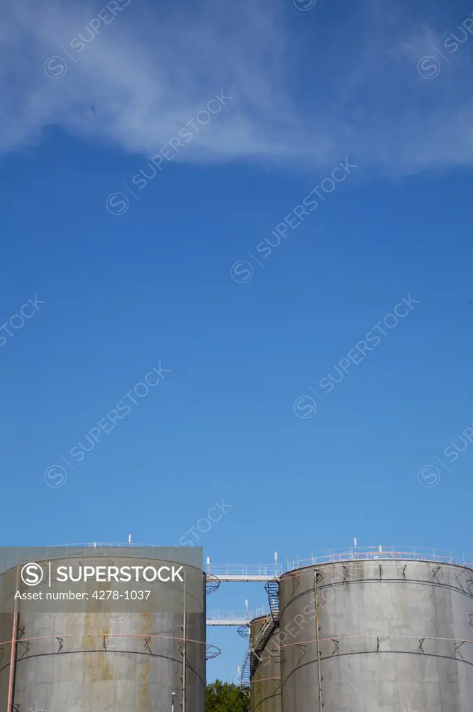 Industrial storage tanks against blue sky