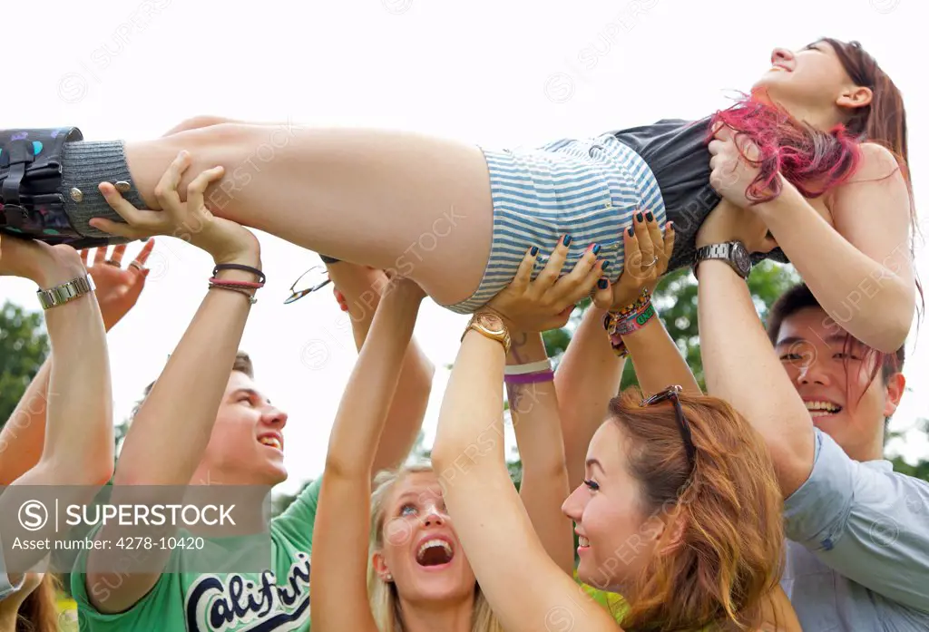 Teenagers Crowd Surfing at Music Festival