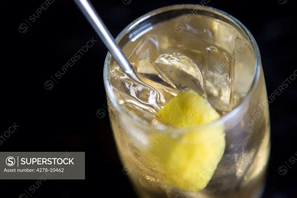 Cocktail with ice cubes and slice of lemon