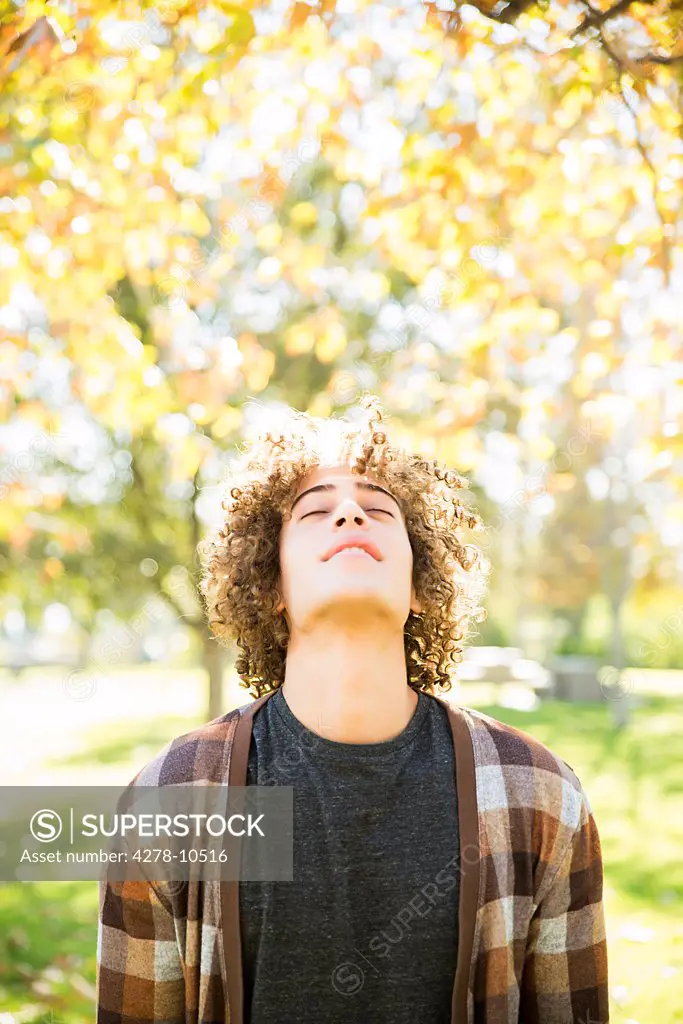 Young Man in Park in Autumn