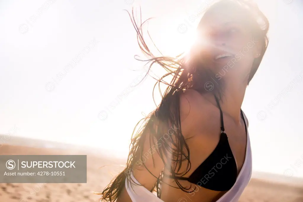 Young Woman on Beach with Windswept Hair