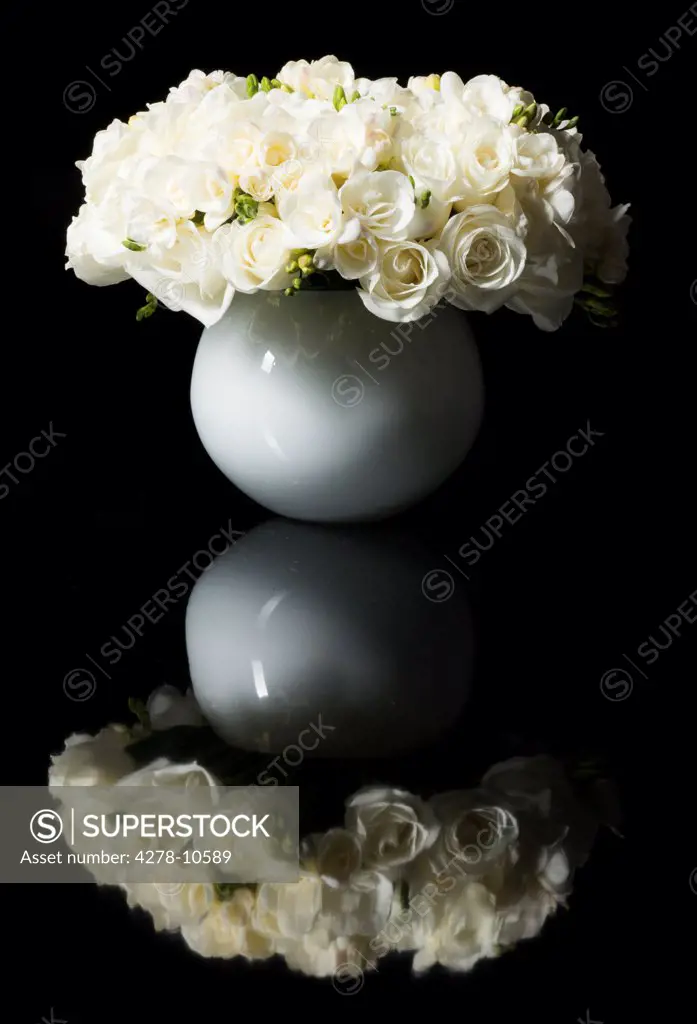 Bouquet of White Roses and Freesia Flowers in a Vase
