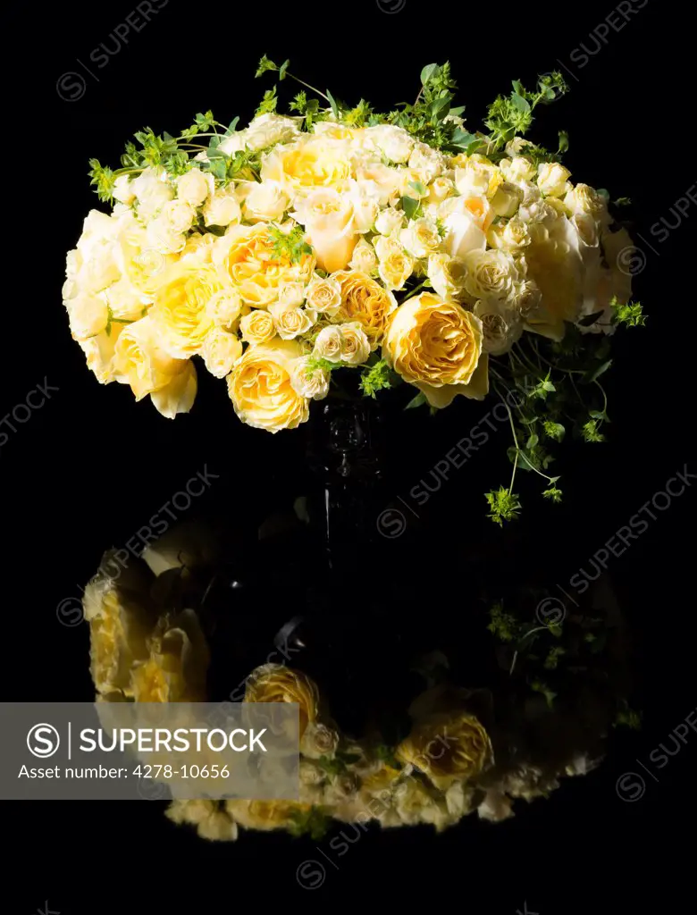 Bouquet of Yellow Roses and Persian Buttercup Flowers in a Vase