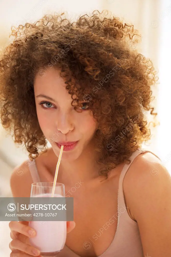 Young Woman Drinking Smoothie with Straw