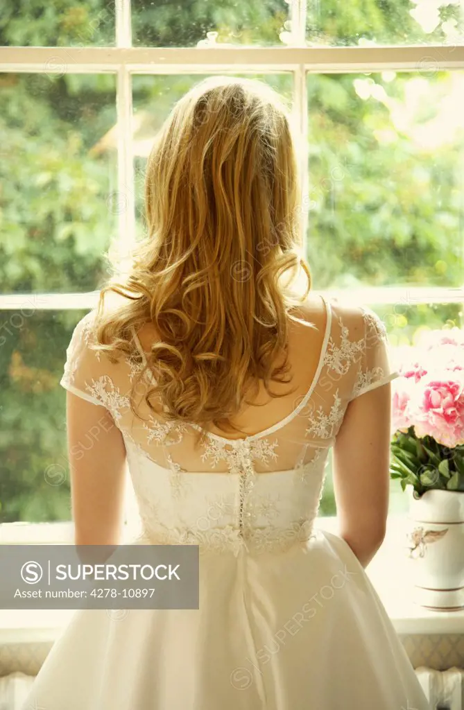 Back View of Young Bride Looking Out of Window