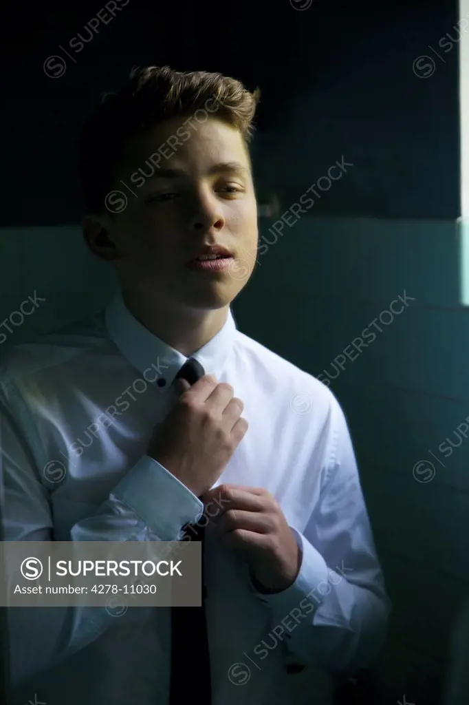 Teenage Boy Adjusting Tie