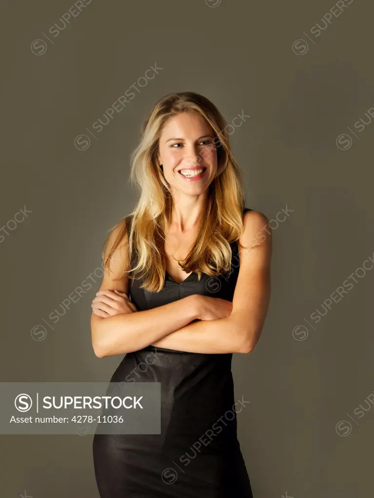 Attractive Blonde Woman with Arms Crossed Smiling
