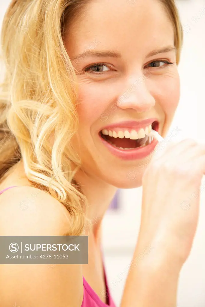 Smiling Woman Brushing Teeth