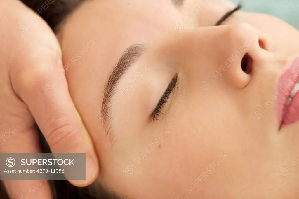 Woman Receiving a Facial Massage, Close-up View