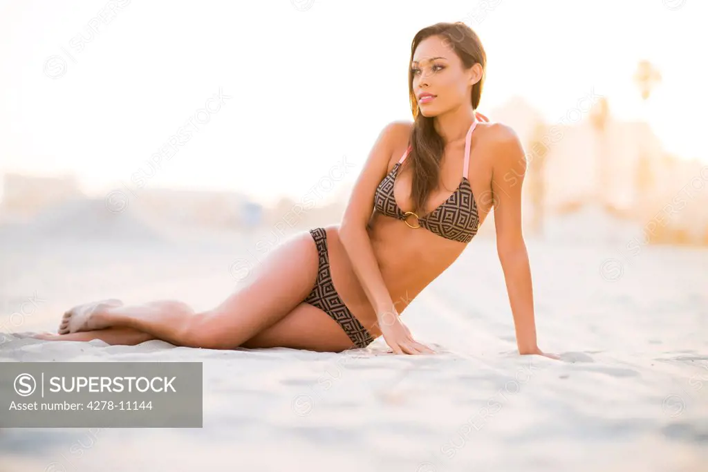 Woman on Beach Sitting on Sand