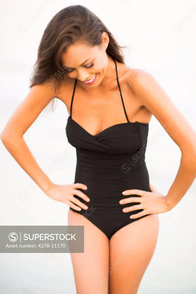Woman Wearing Black Swimsuit with Hands on Hips