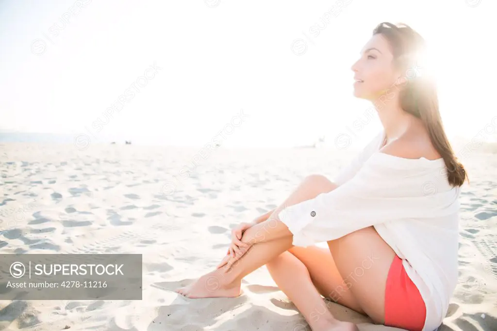 Woman Sitting on Sand
