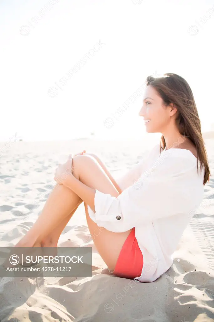 Woman Sitting on Sand