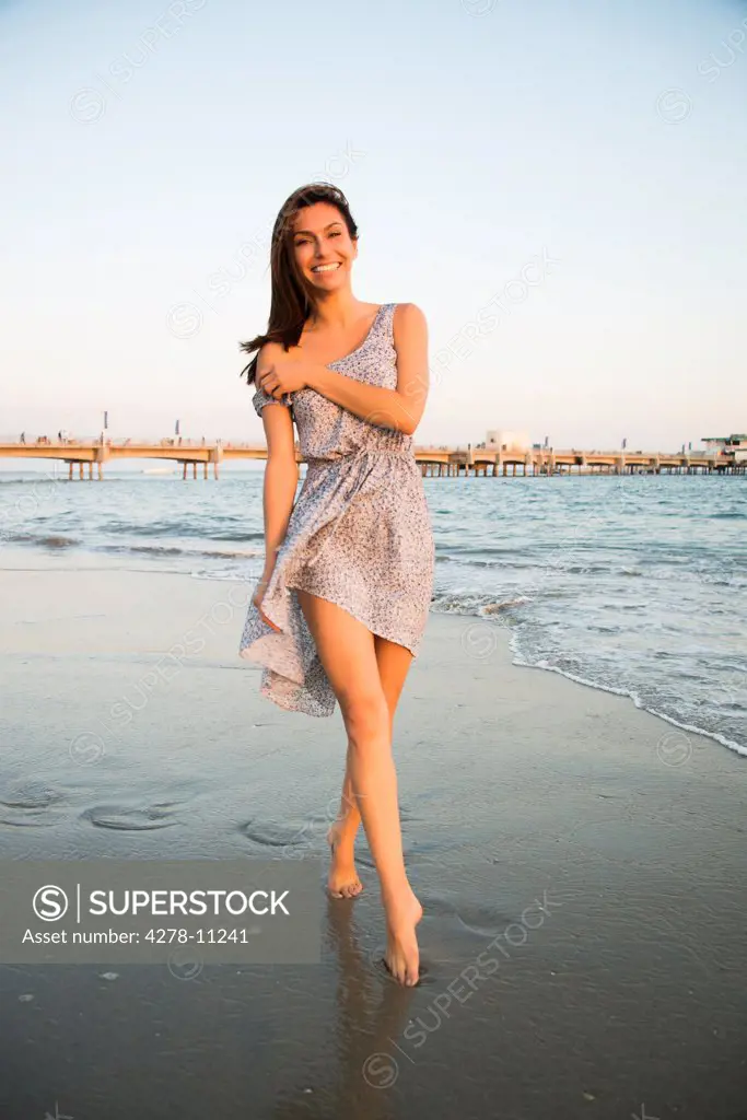 Woman Walking Barefoot on Beach Shore