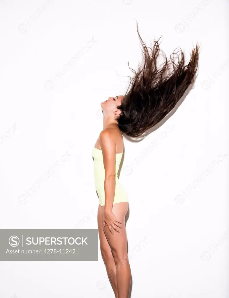 Profile of Young Woman Flipping Long Hair