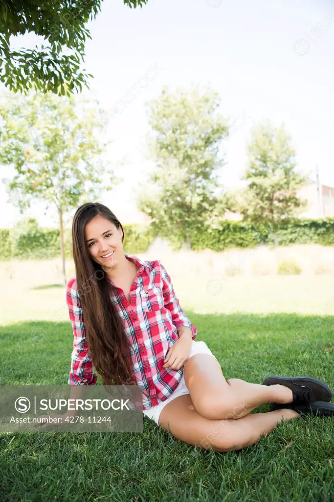 Young Woman Sitting in Park
