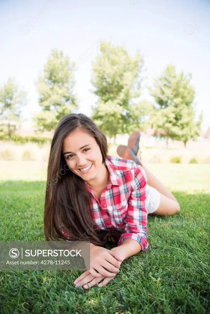 Smiling Woman Lying on Grass