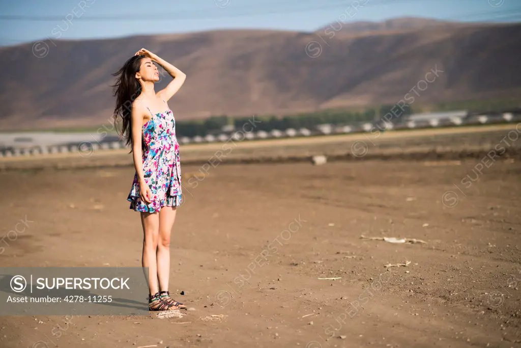 Woman Standing on Dry Field
