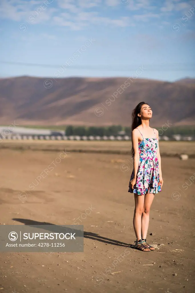 Woman Standing on Dry Field