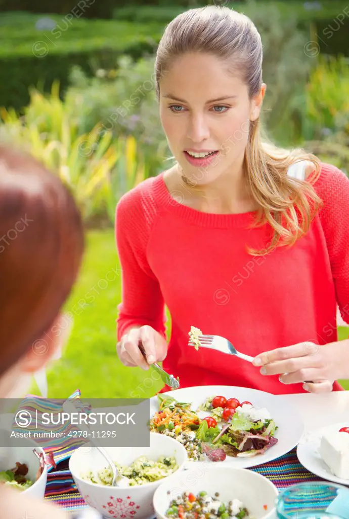 Woman Having Lunch in Garden with Friend