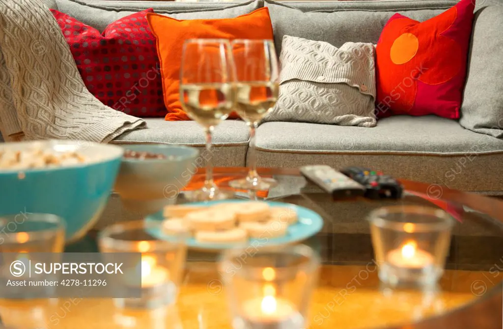 Cosy Sofa and Coffee Table with Wine, Snacks and Tea lights