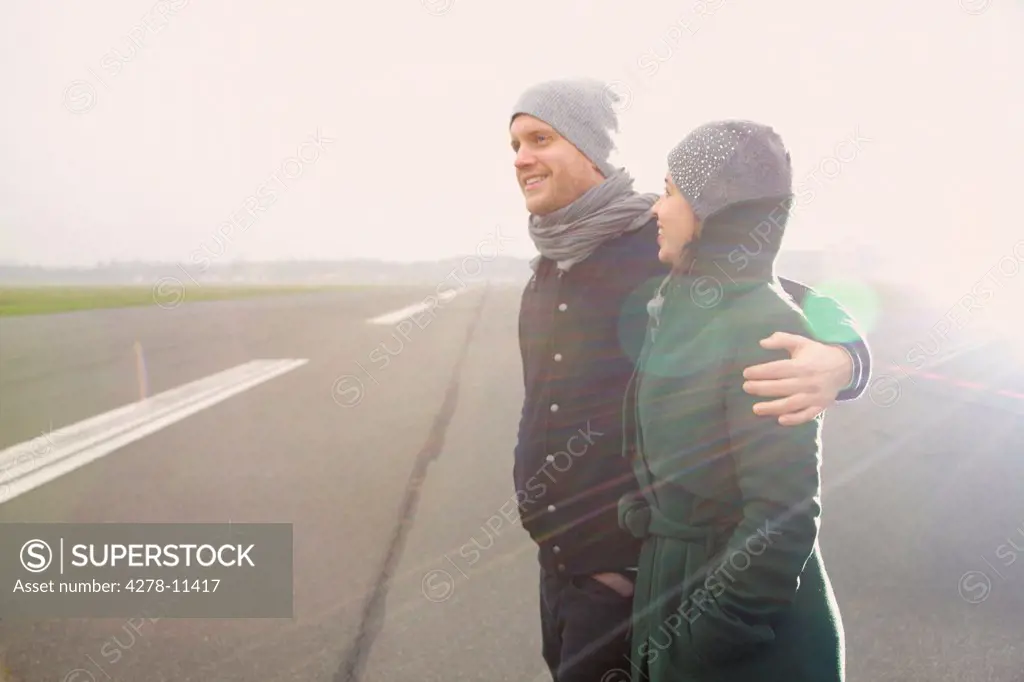 Smiling Couple Standing on Airport Runway