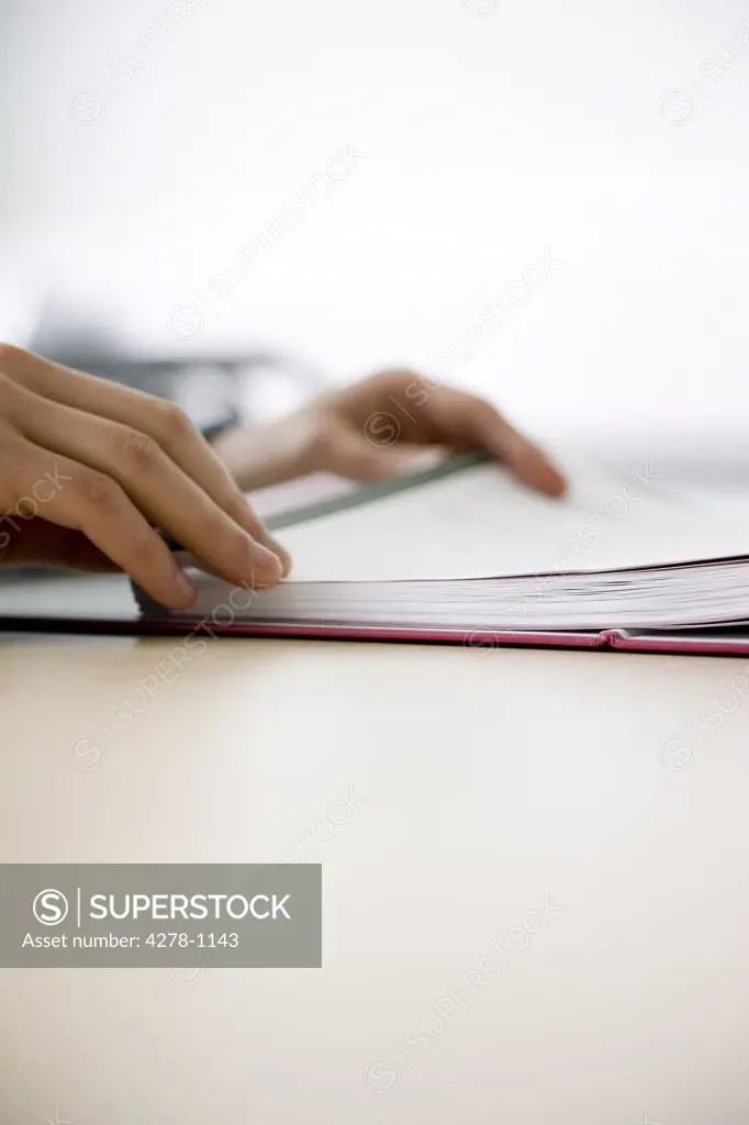 Close up of man's hands checking file