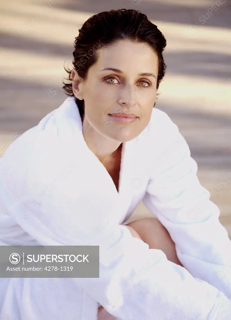 Woman in white bathrobe smiling