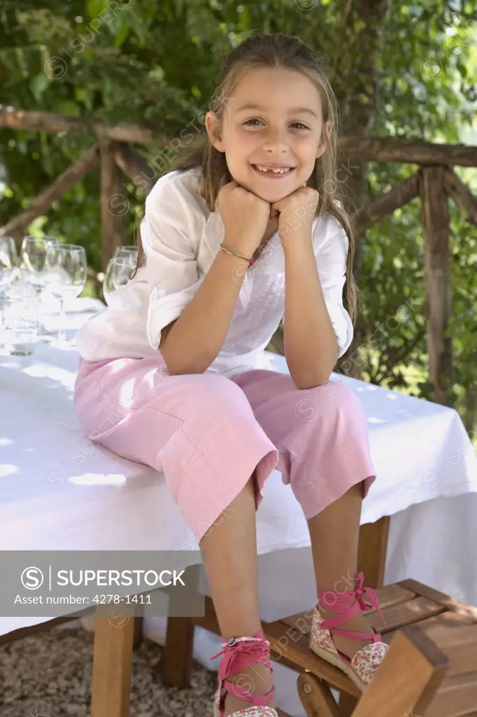 Portrait of a girl sitting on table