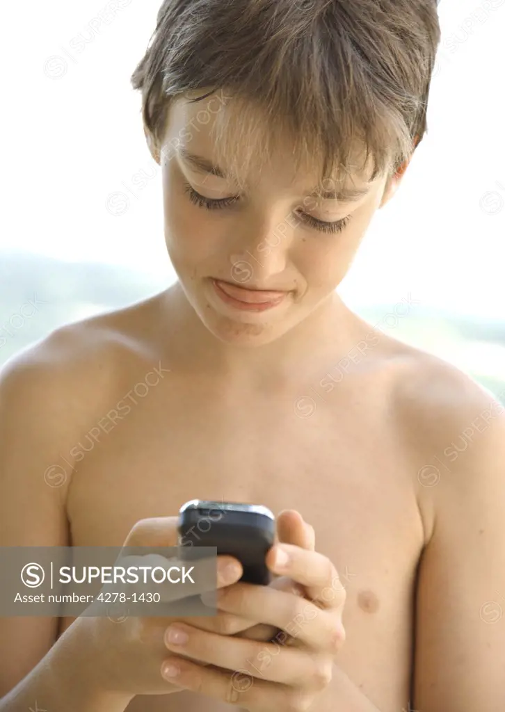 Boy texting on cell phone