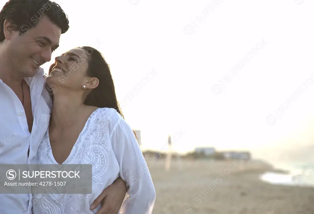 Couple Walking on Beach Smiling