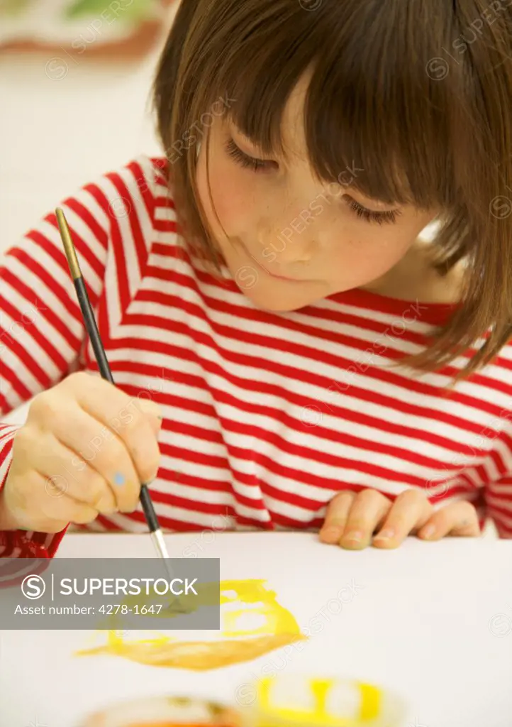 Portrait of a girl painting with watercolor