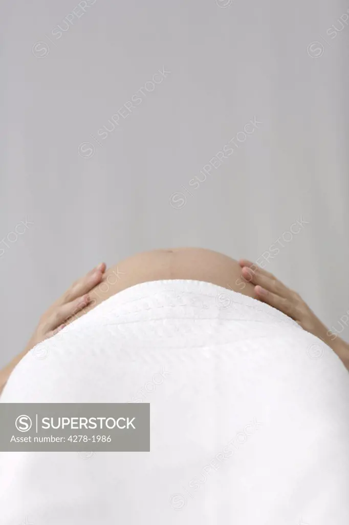 Close up of pregnant woman hands on stomach