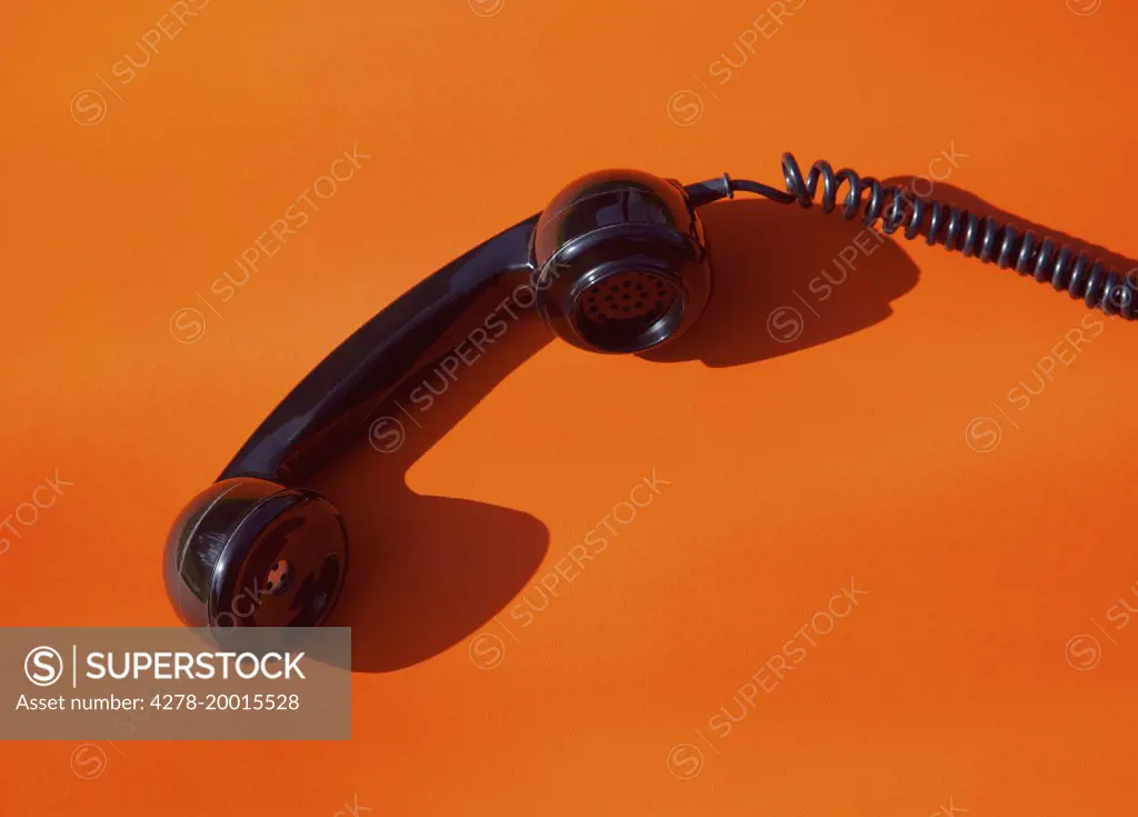 Telephone Handset on Orange Background
