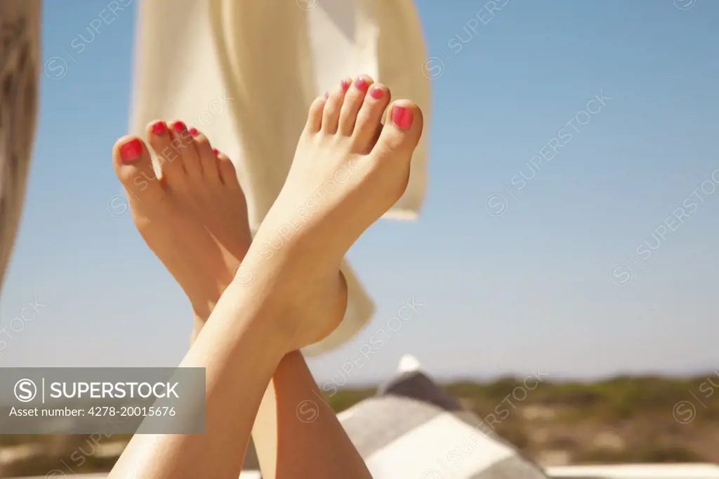 Woman's Feet in the Air with Bright Pink Toenails