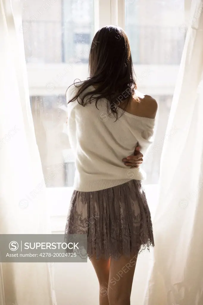 Back View of Woman Looking Out Window