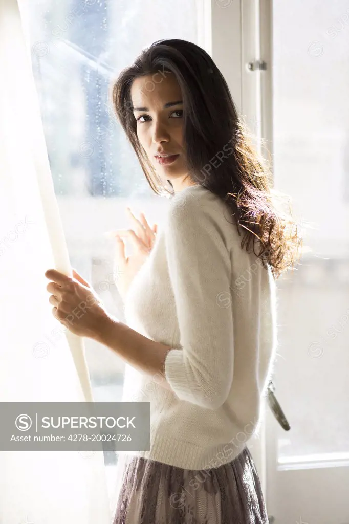 Woman Standing at Window