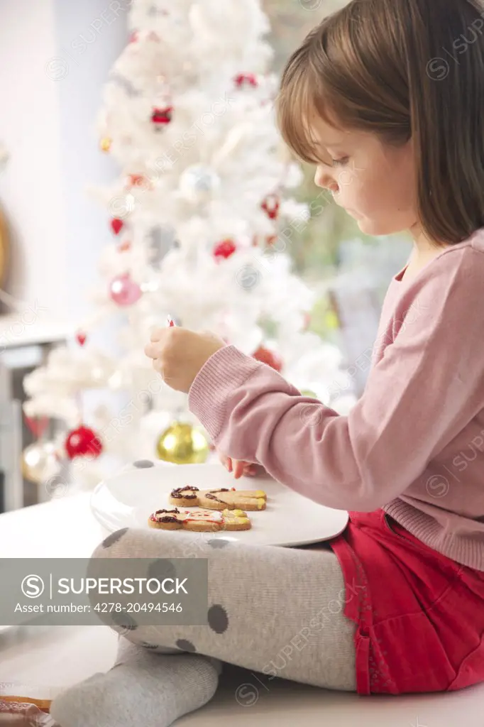 Young Girl Decorating Ginger bread man Biscuits